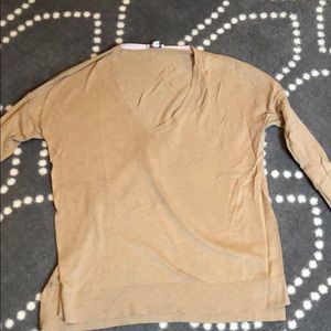 Tan colored sweater.